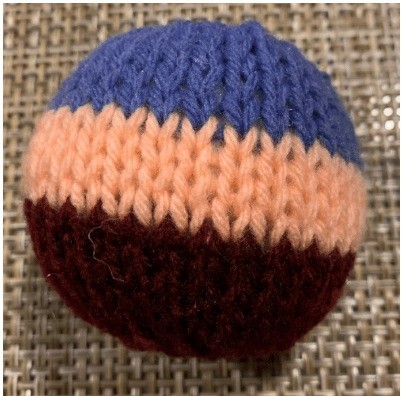 A photo of a knitted snowball toy - an available free handcrafted item from Community Threads