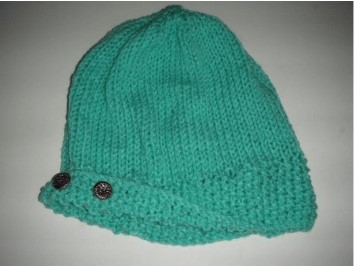 A photo of a knitted winter hat with brim - an available free handcrafted item from Community Threads