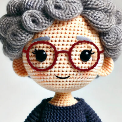 Crochet doll version of Marcia, King George Coordinator of Community Threads.