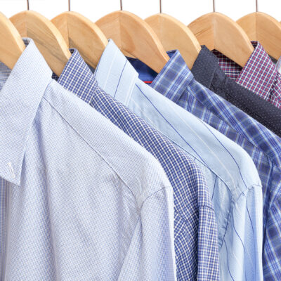 A rack of men's shirts representing the free men's clothing that Community Threads distributes to the community.