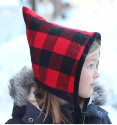 a girl modeling a sewn hat - an available free handcrafted item from Community Threads